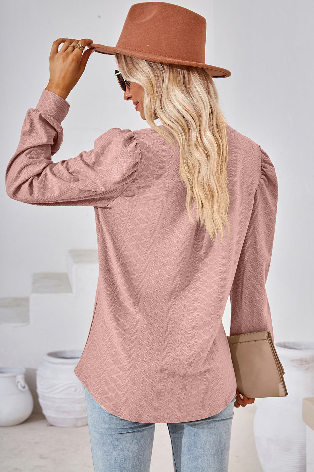Blush pink textured puff sleeve henley blouse with a diamond pattern.