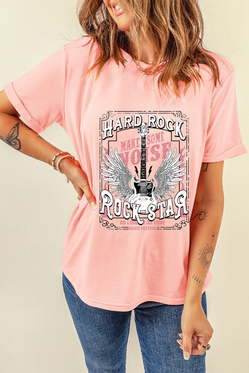 Watermelon pink graphic tee with a Hard Rock Rock Star guitar and wings design.