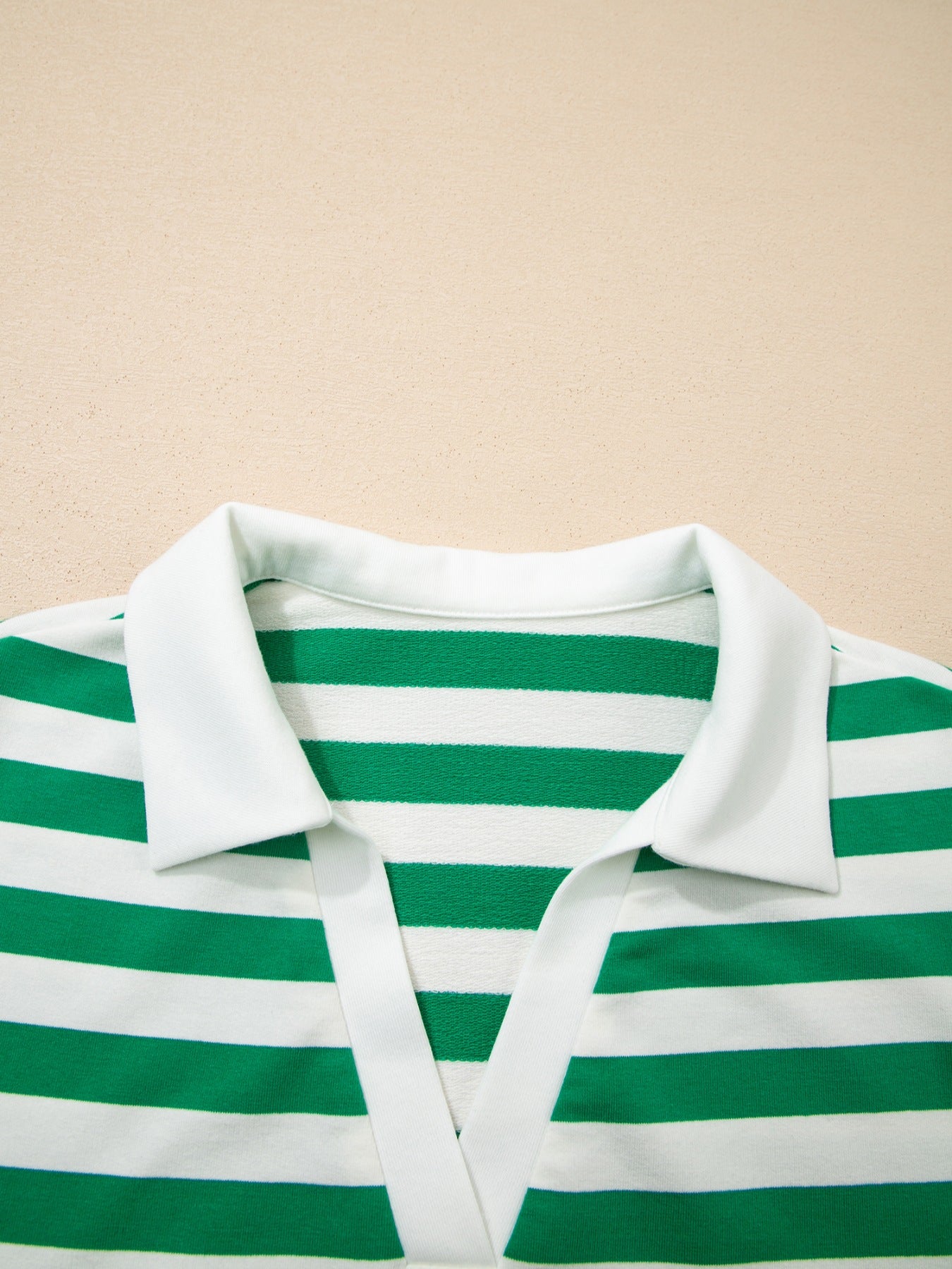 Green and white striped cotton blouse with a white collar and V-neck detail.