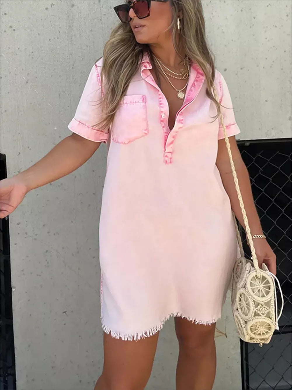 Pink short sleeve collared dress with frayed hem and chest pocket.