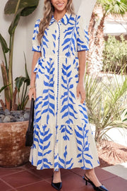 Botanical print maxi dress with side tie, collared neckline, button-down front, and tiered skirt.