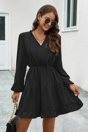 Black tiered ruffle sleeve mini dress with v-neck and tie detail