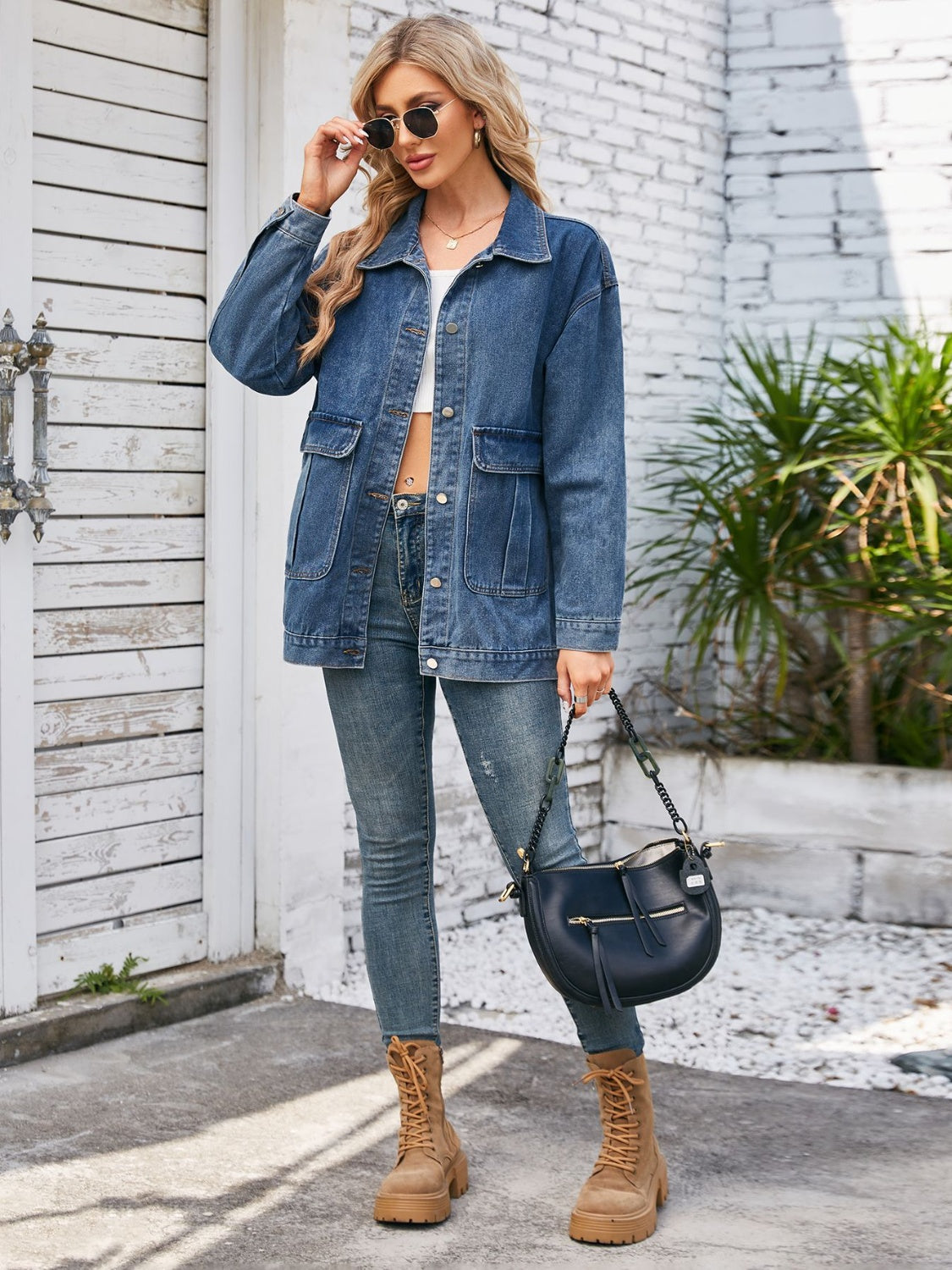 Denim button-up jacket in dusty blue with chest pockets and a relaxed fit.