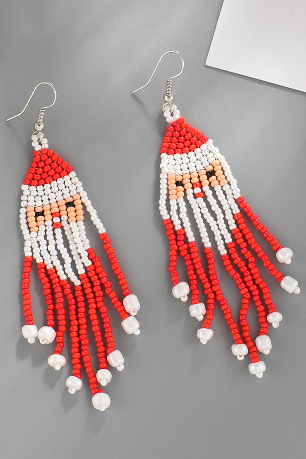 Beaded Santa drop earrings with red, white, and peach beads.