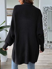 Black ribbed knit cardigan with pearl buttons, long sleeves, and a relaxed fit.