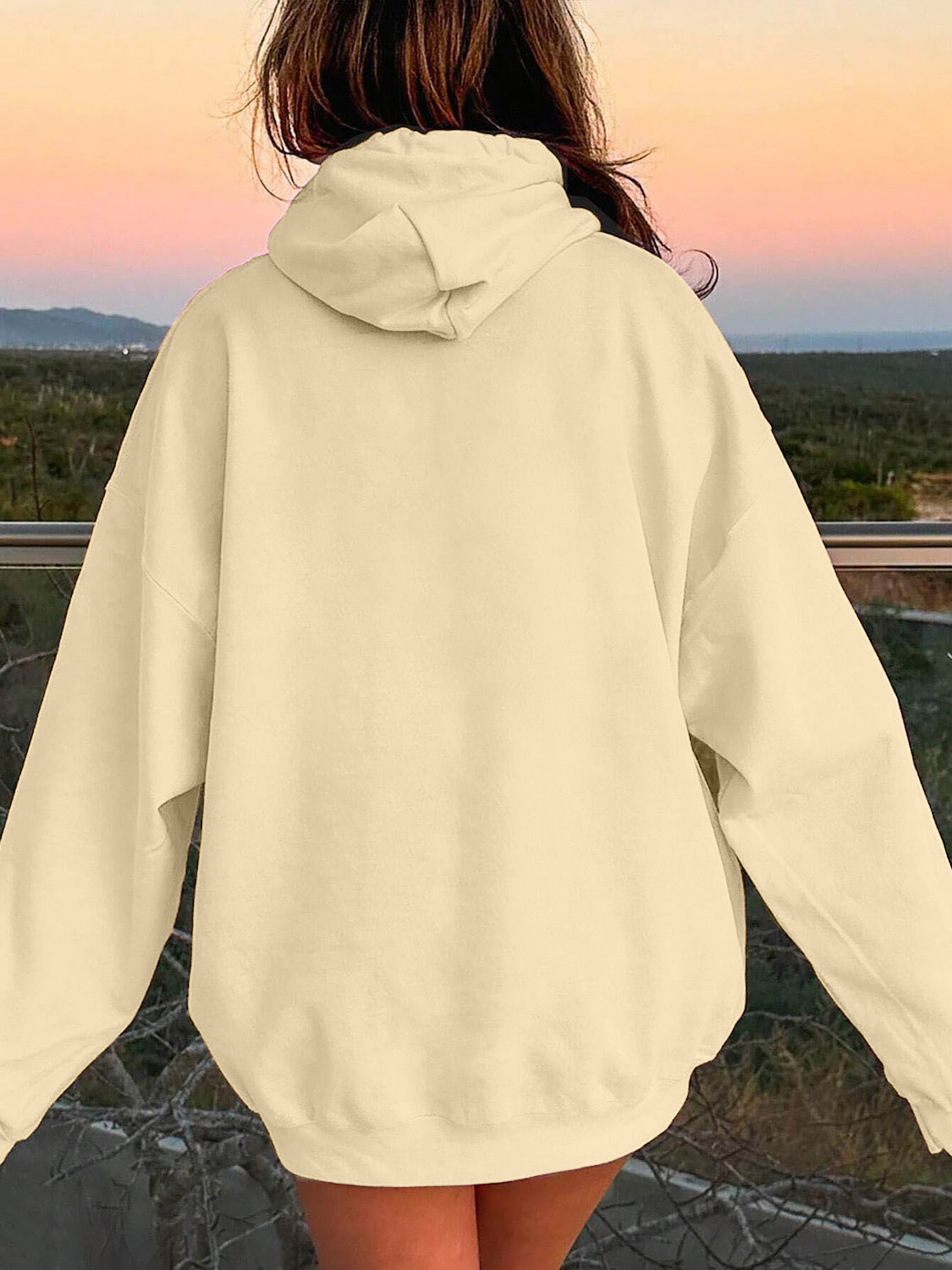 Oversized light yellow hoodie with pouch pocket and hood.