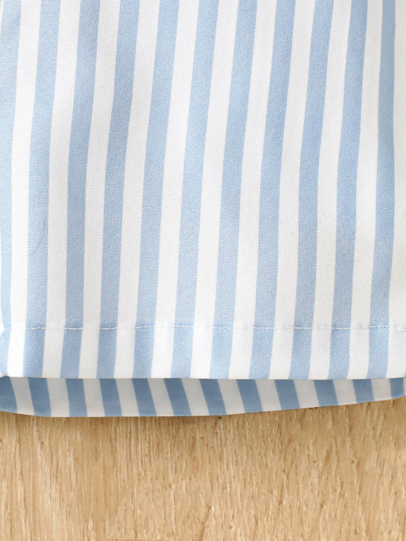 Striped baby tee and shorts set in pastel blue and white cotton.