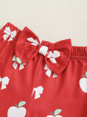 Red baby bodysuit with white apple and bow print and a satin bow detail.