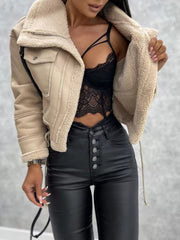 Cropped beige sherpa-trim jacket with buttoned front and zip pocket detail.