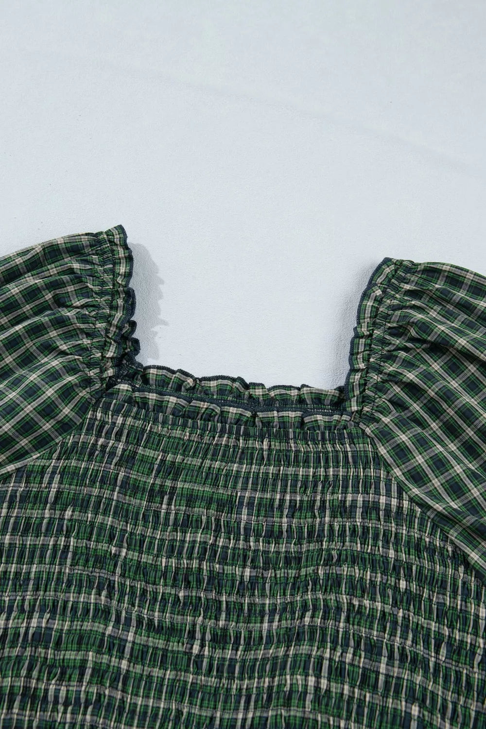 Plaid maxi dress with square neckline, smocked bodice, and ruffled short sleeves in green cotton.