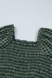 Plaid maxi dress with square neckline, smocked bodice, and ruffled short sleeves in green cotton.