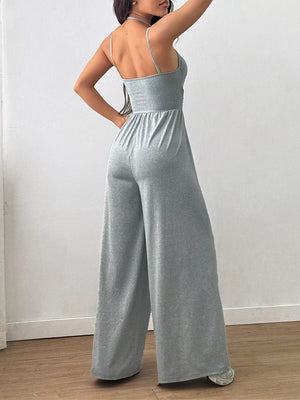 Gray wide-leg jumpsuit with spaghetti straps and elastic waist.