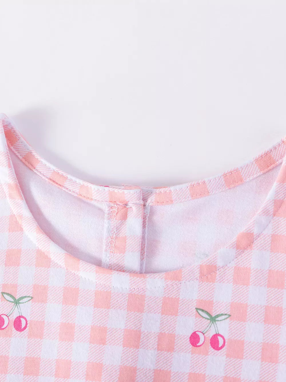 Baby dress with pink gingham and cherry embroidery, cotton fabric.