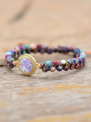 Multicolor beaded bracelet with iridescent orb and jasperite beads, gold accent.