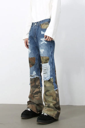 Camouflage patchwork distressed jeans in medium wash denim with baggy fit and frayed hems.