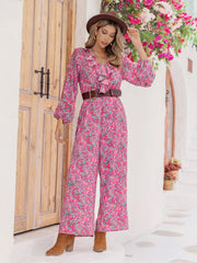 Paisley ruffle front wide leg jumpsuit in hot pink with long sleeves and a v-neck.