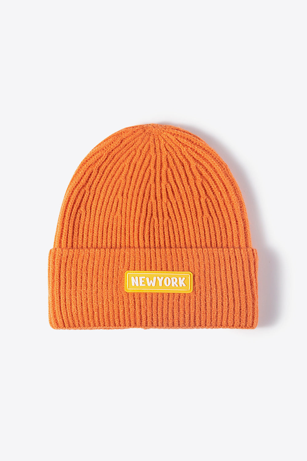 Orange ribbed acrylic beanie with New York patch