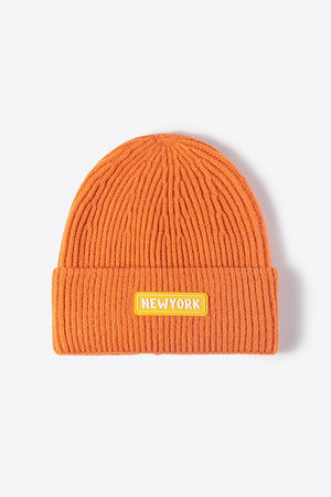 Orange ribbed acrylic beanie with New York patch