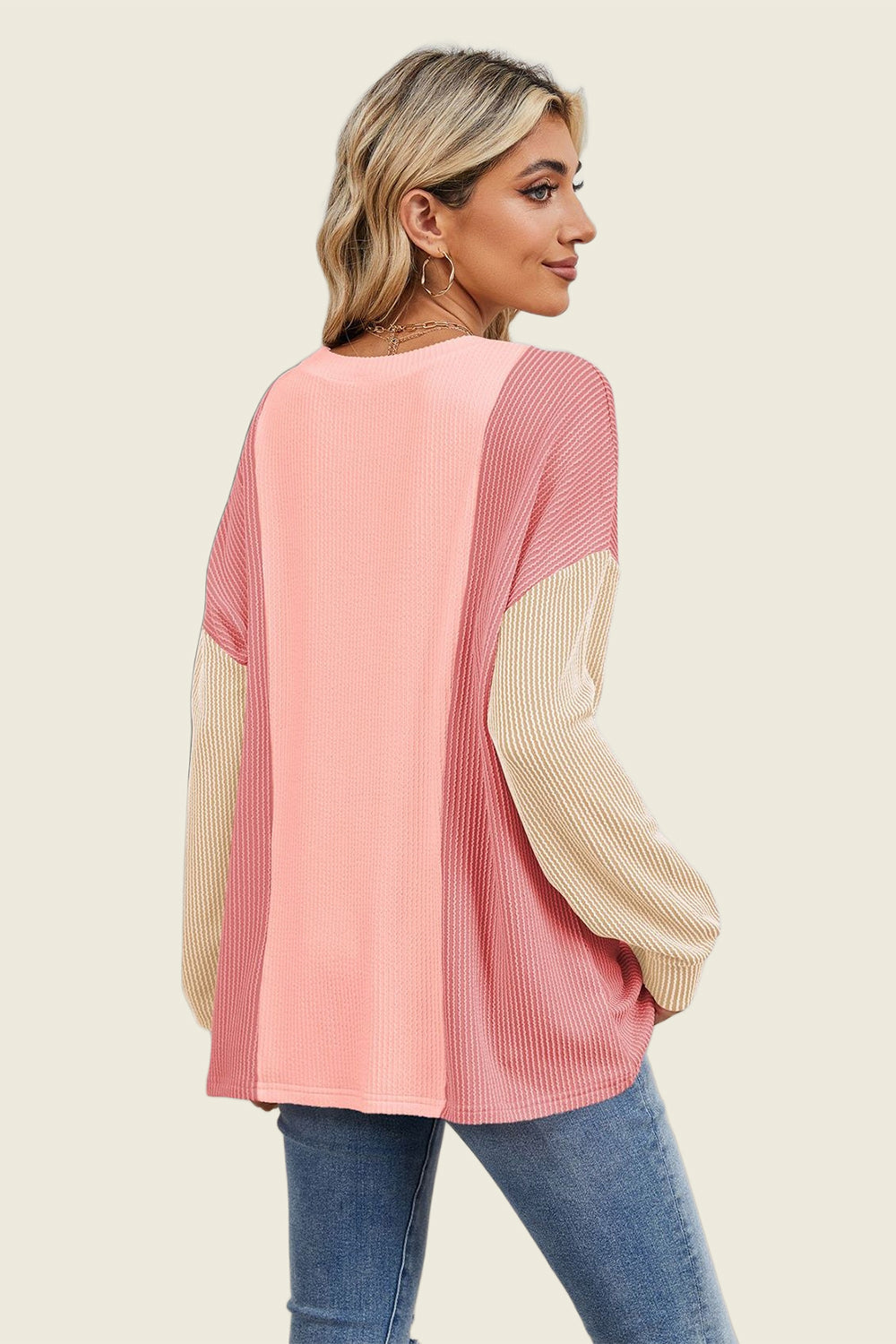 Colorblock waffle knit pullover sweater in pink and tan, featuring a crew neck and long sleeves.