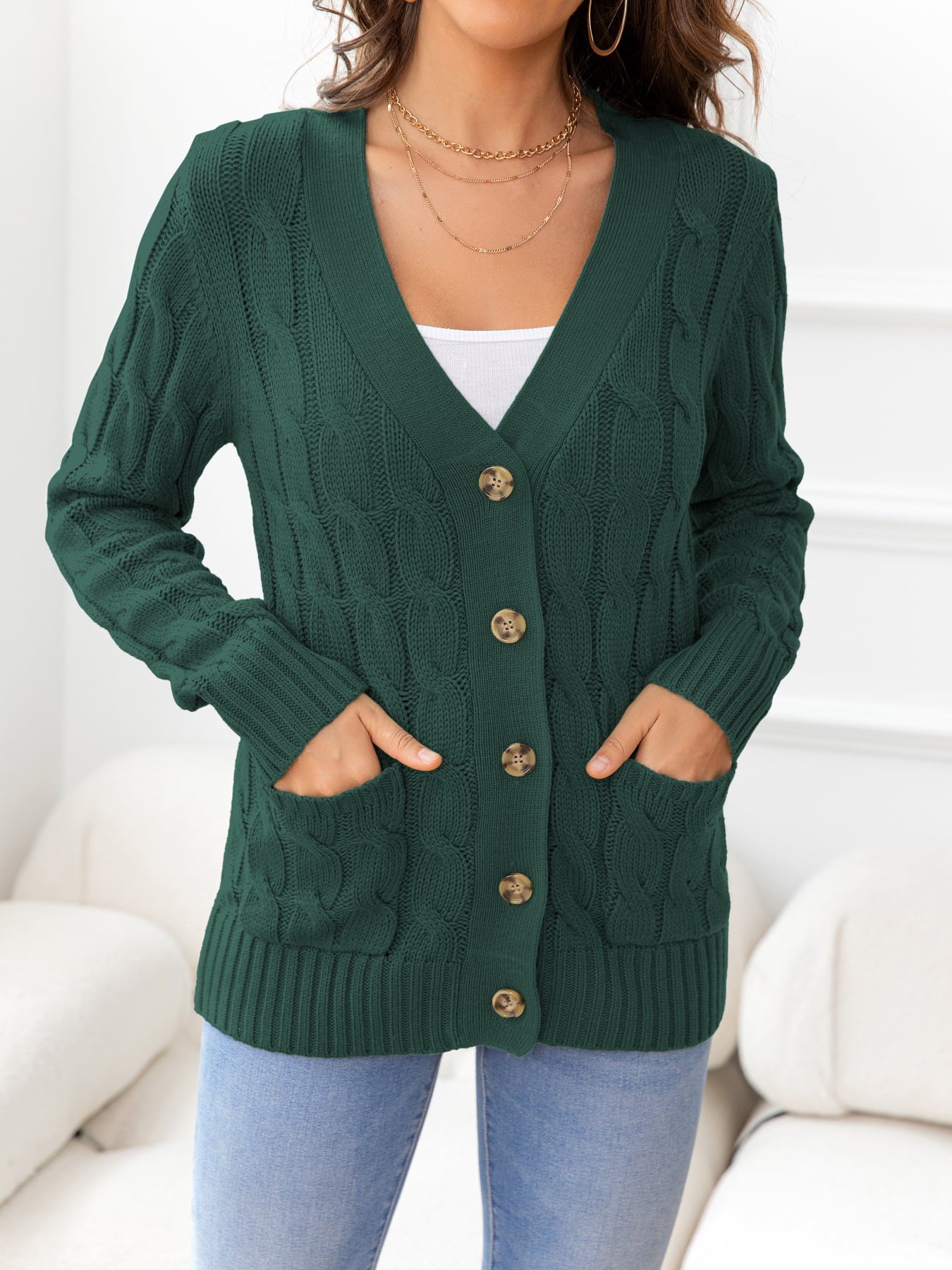 Textured cable-knit cardigan in Gum Leaf green with button front and patch pockets.