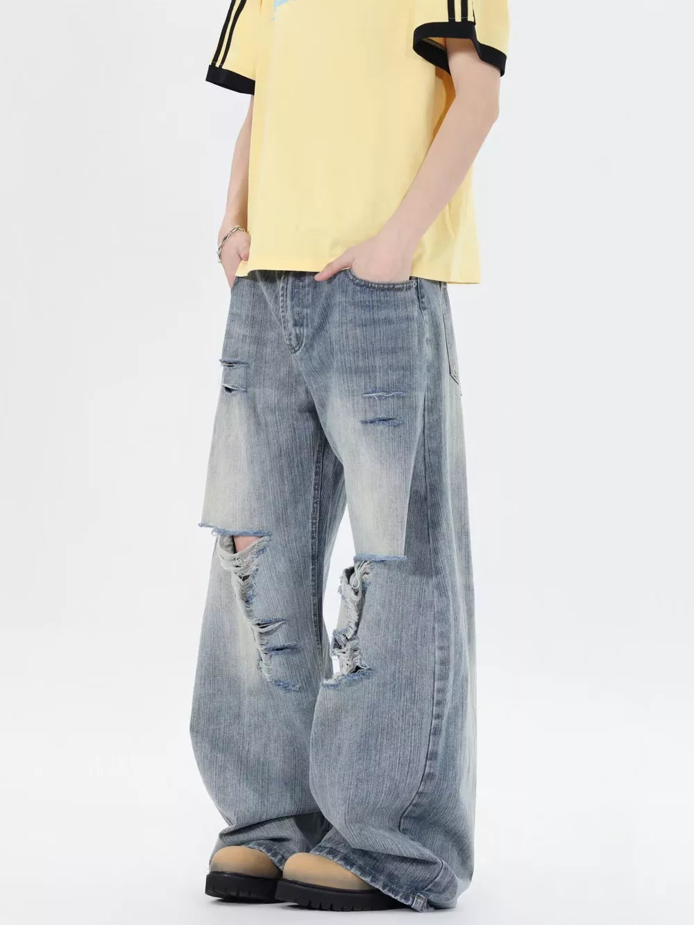 Men's light wash distressed wide-leg jeans, 100% cotton, relaxed fit.