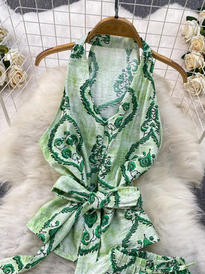 Green tropical print halter top with belted detail and matching shorts.