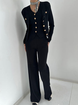 Black ribbed knit outfit set with gold buttons, featuring a cardigan and wide-leg pants.