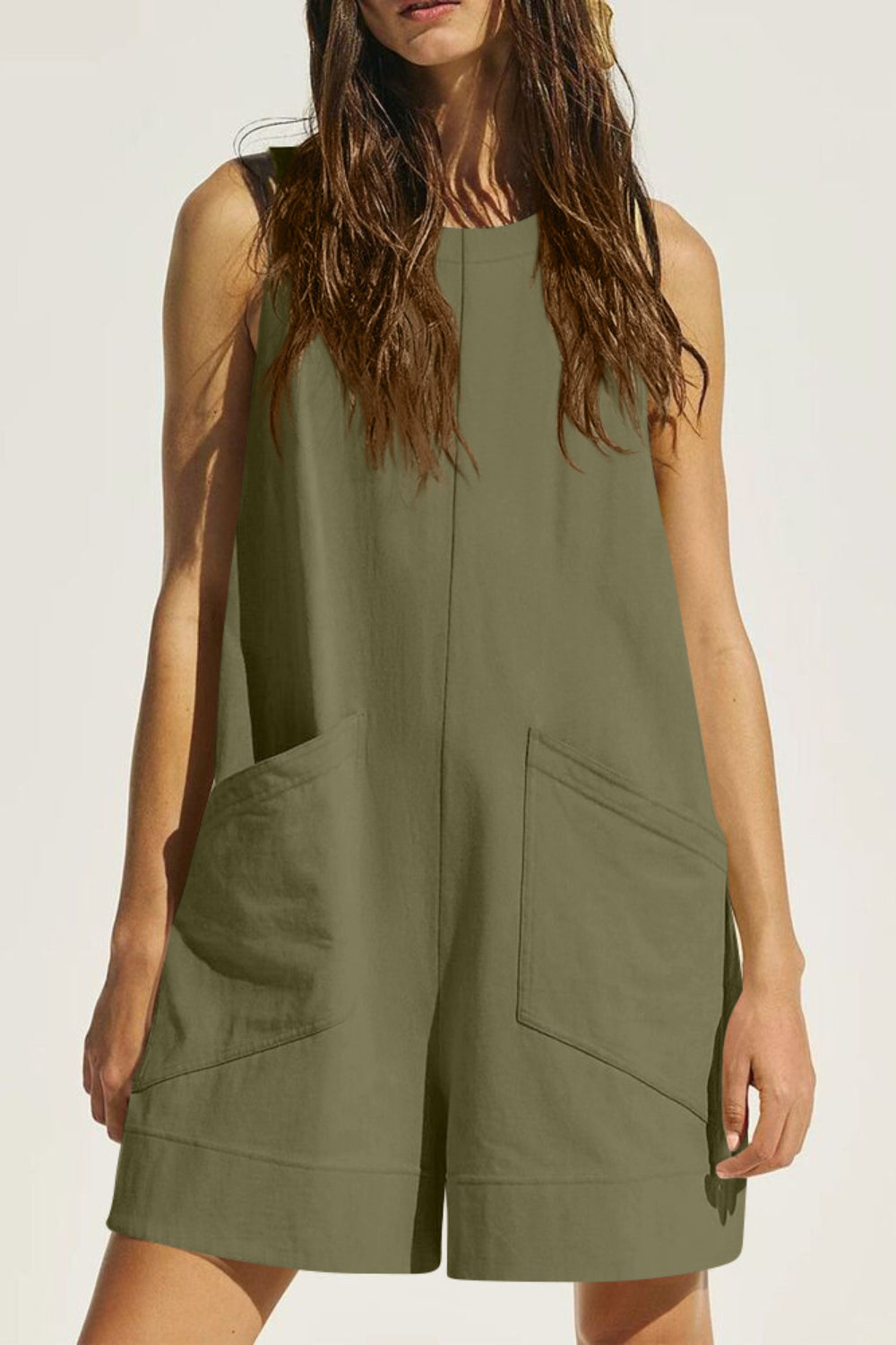Relaxed fit sleeveless linen romper in Matcha Green with large front pockets.