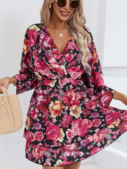 Floral ruffle hem mini dress in black with pink and yellow flowers, V-neck, and flowy sleeves.