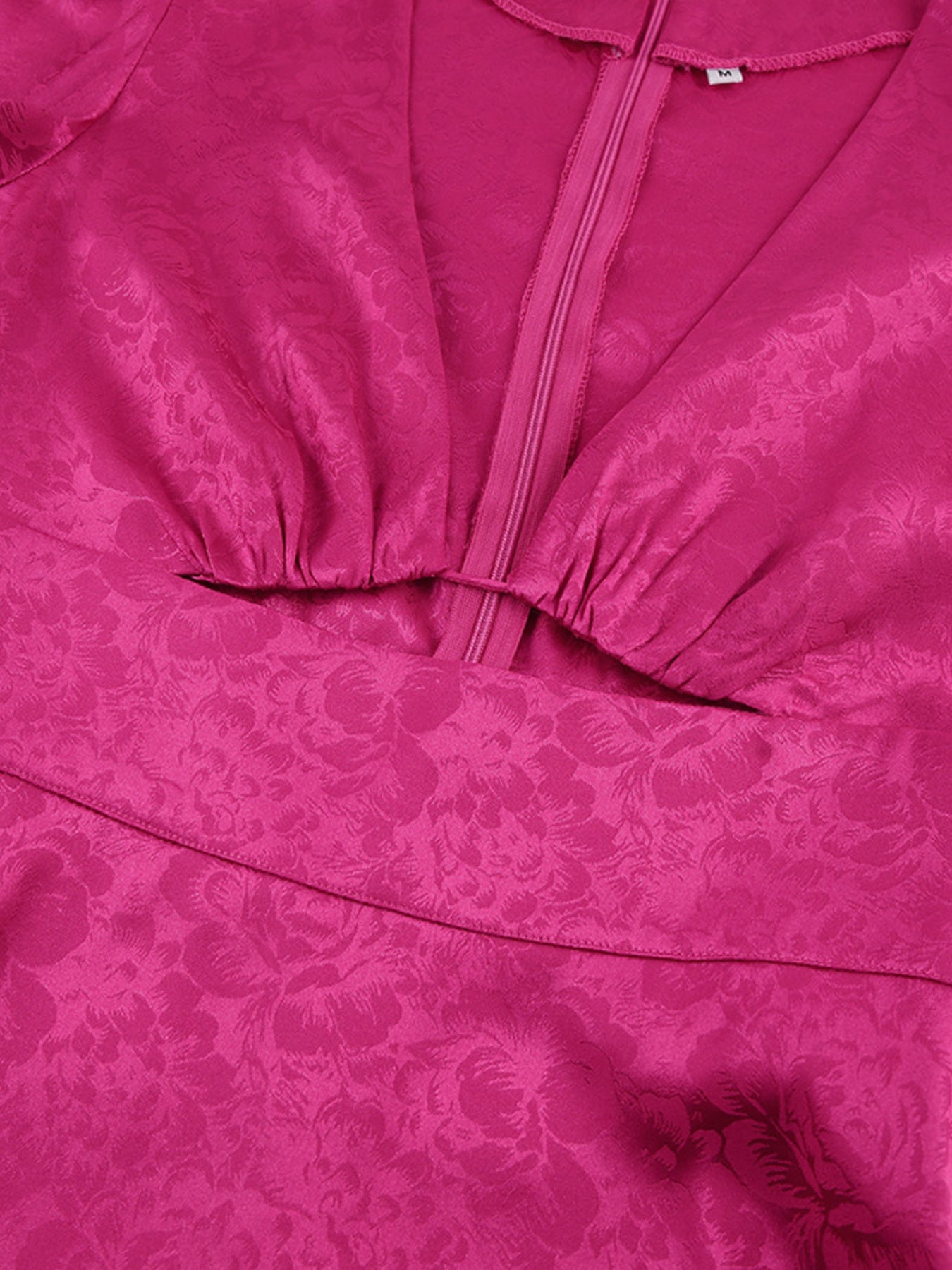 Vibrant cerise mini dress with deep V-neck, cutout detail, and floral jacquard pattern.