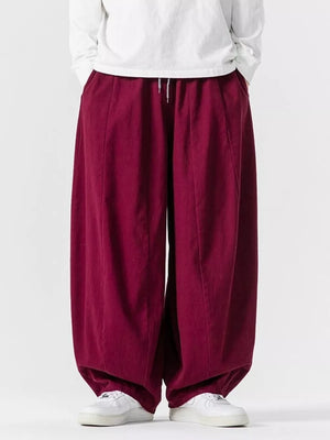 Burgundy relaxed fit drawstring sweatpants with baggy legs and pockets.