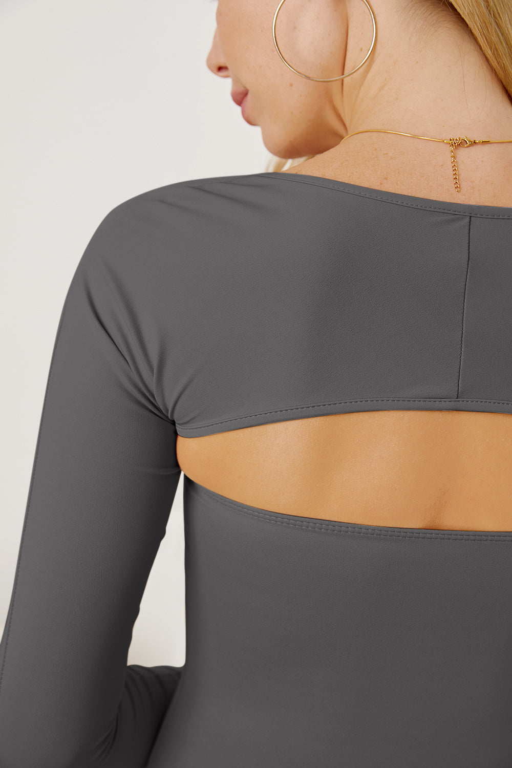 Dark gray long sleeve bodysuit with open back detail