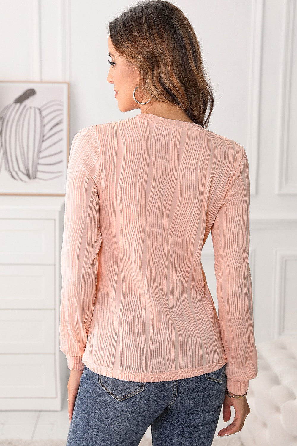 Textured wave crewneck pullover in blush pink with long sleeves and a crew neckline.