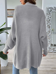 Gray ribbed knit cardigan with pearl buttons and a relaxed fit.