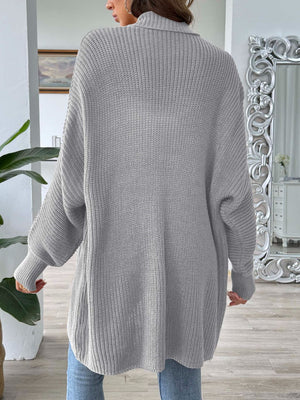Gray ribbed knit cardigan with pearl buttons and a relaxed fit.