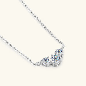 Silver moissanite cluster pendant necklace with D color stones on a delicate chain.