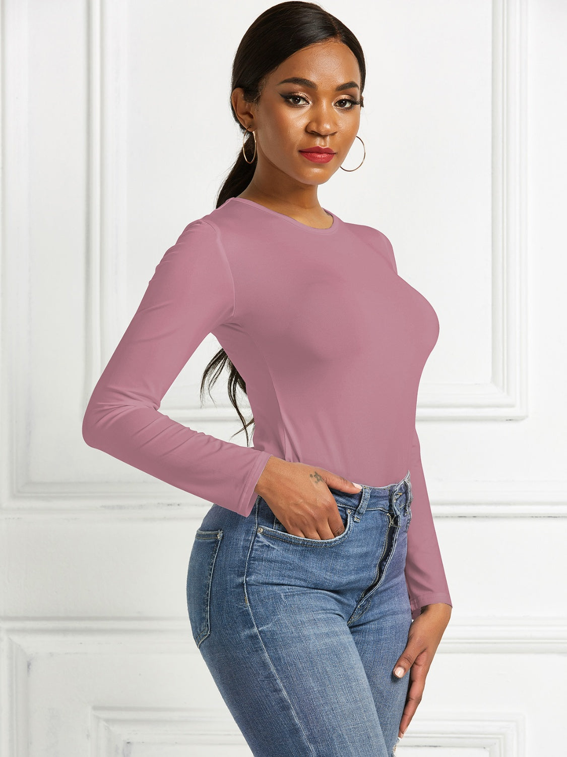 Sculpted ribbed jersey bodysuit in dusty pink with long sleeves and a crew neck.