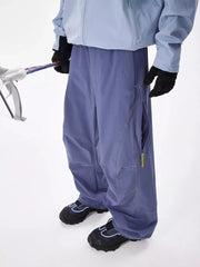 Men's blue loose fit cargo sweatpants with zippered pockets and contrast stitching.