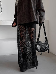 Black lace maxi skirt with sheer detail, featuring a floral pattern and floor-length cut.