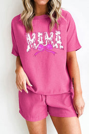 Fuchsia pink waffle knit loungewear set with "Mama" graphic and bow detail.