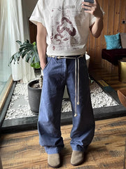 Men's relaxed fit blue sweatpants with drawstring and pockets.
