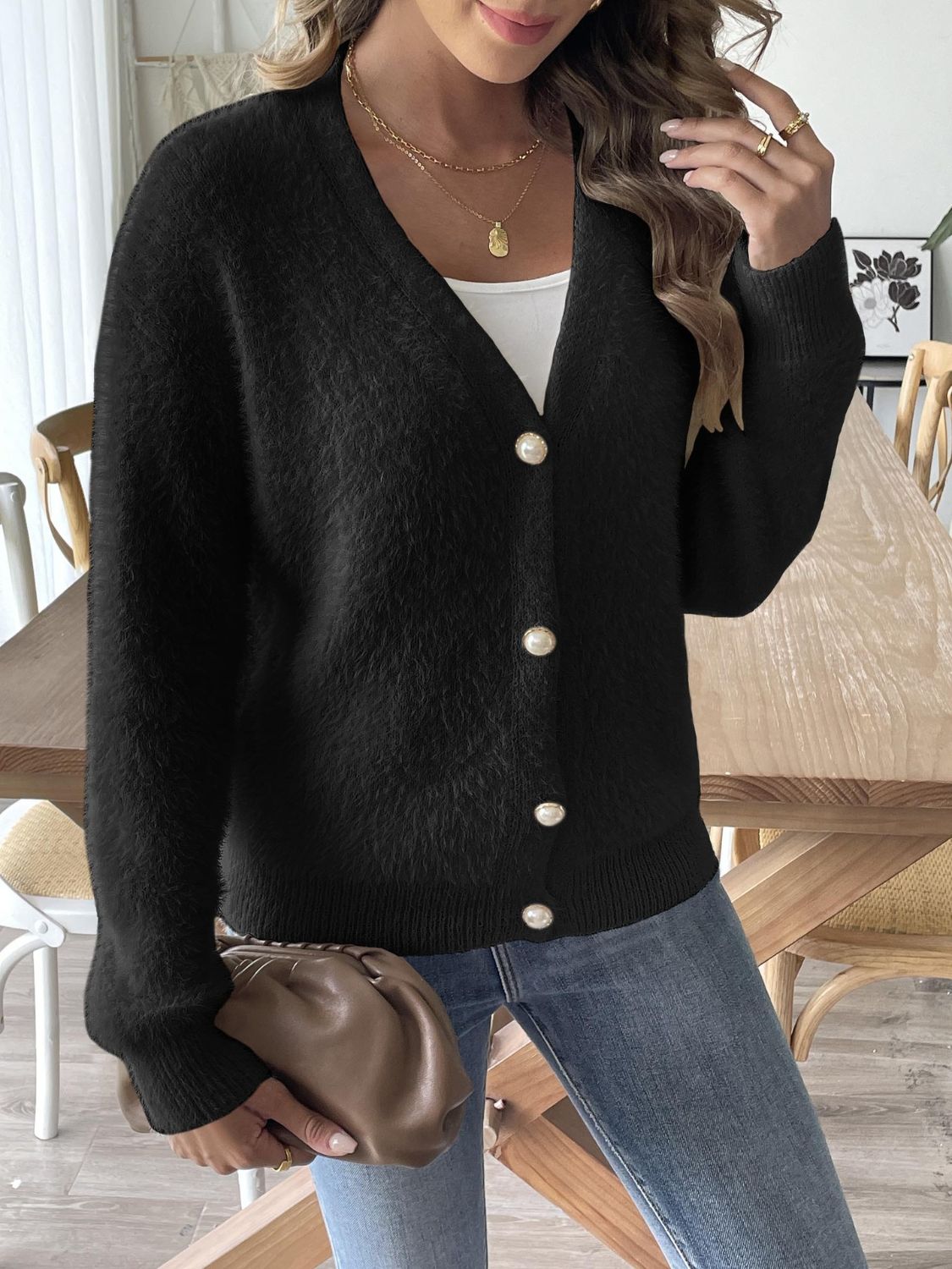 Black plush button-down cardigan with pearl details and V-neck.