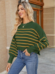 Cropped green knit sweater with yellow stripes, balloon sleeves, and ribbed cuffs.