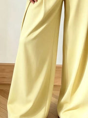 Yellow wide-leg pants with a flowing cut and subtle pleats.