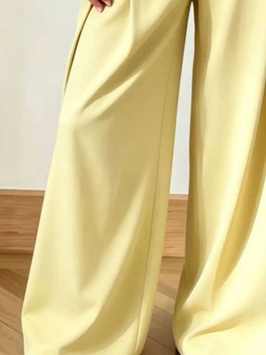 Yellow wide-leg pants with a flowing cut and subtle pleats.