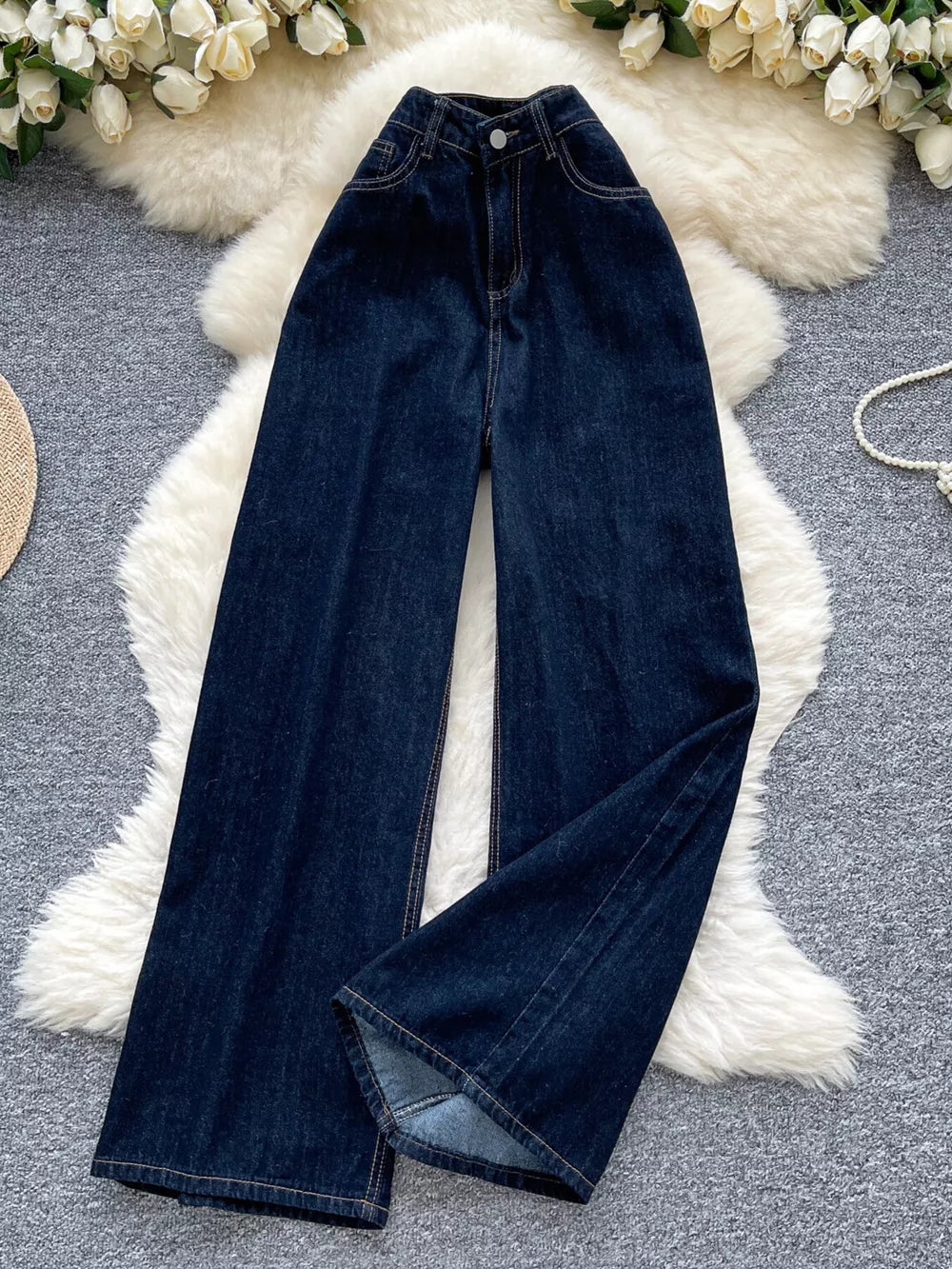 Dark wash denim maternity jeans with a high rise and wide leg cut.