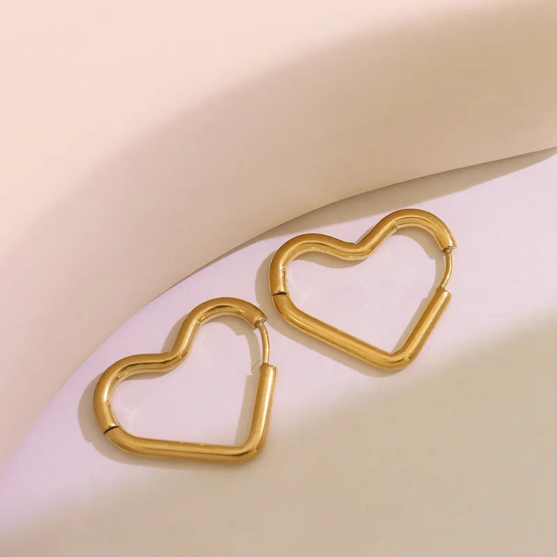 Gold heart huggie earrings made of steel