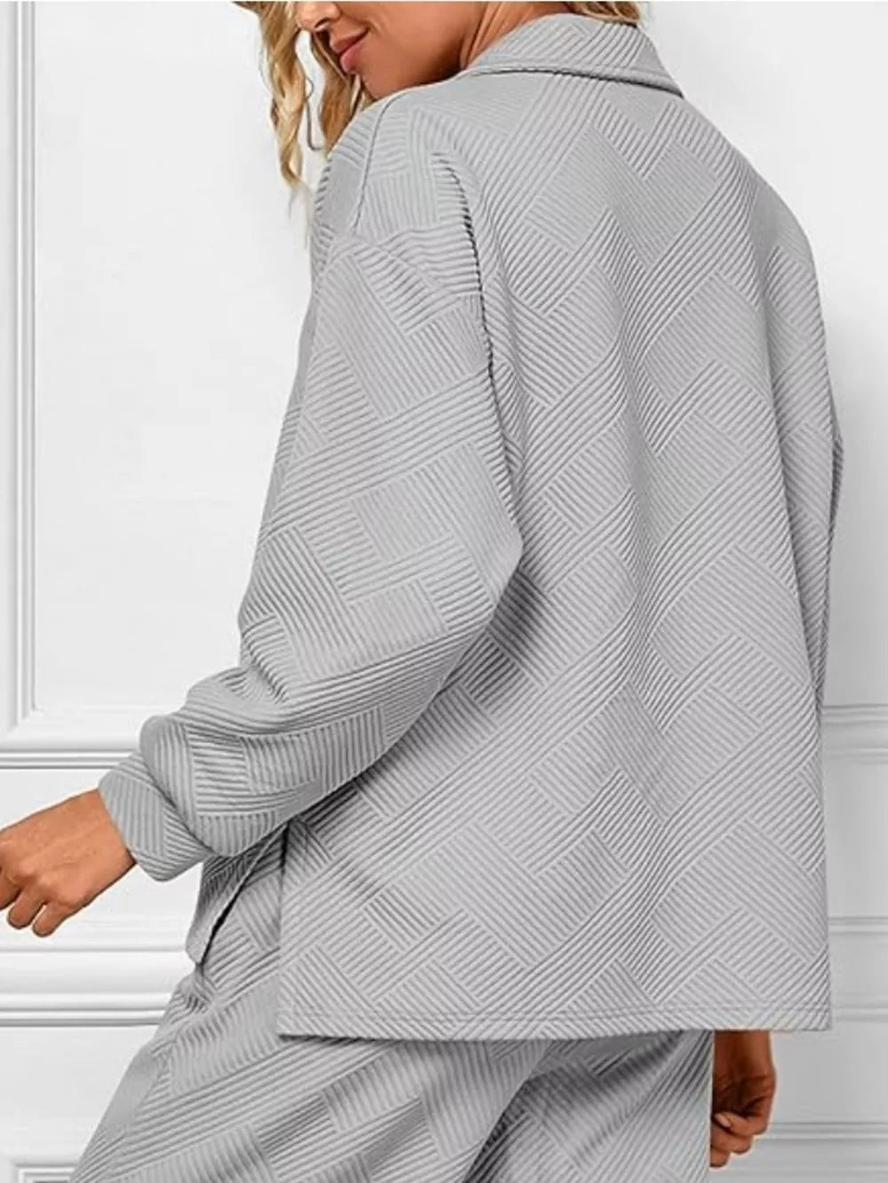Gray textured lounge set with diagonal pattern, V-neck top and matching pants.