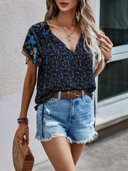 Bohemian floral print blouse with flutter sleeves and v-neck in multicolor.