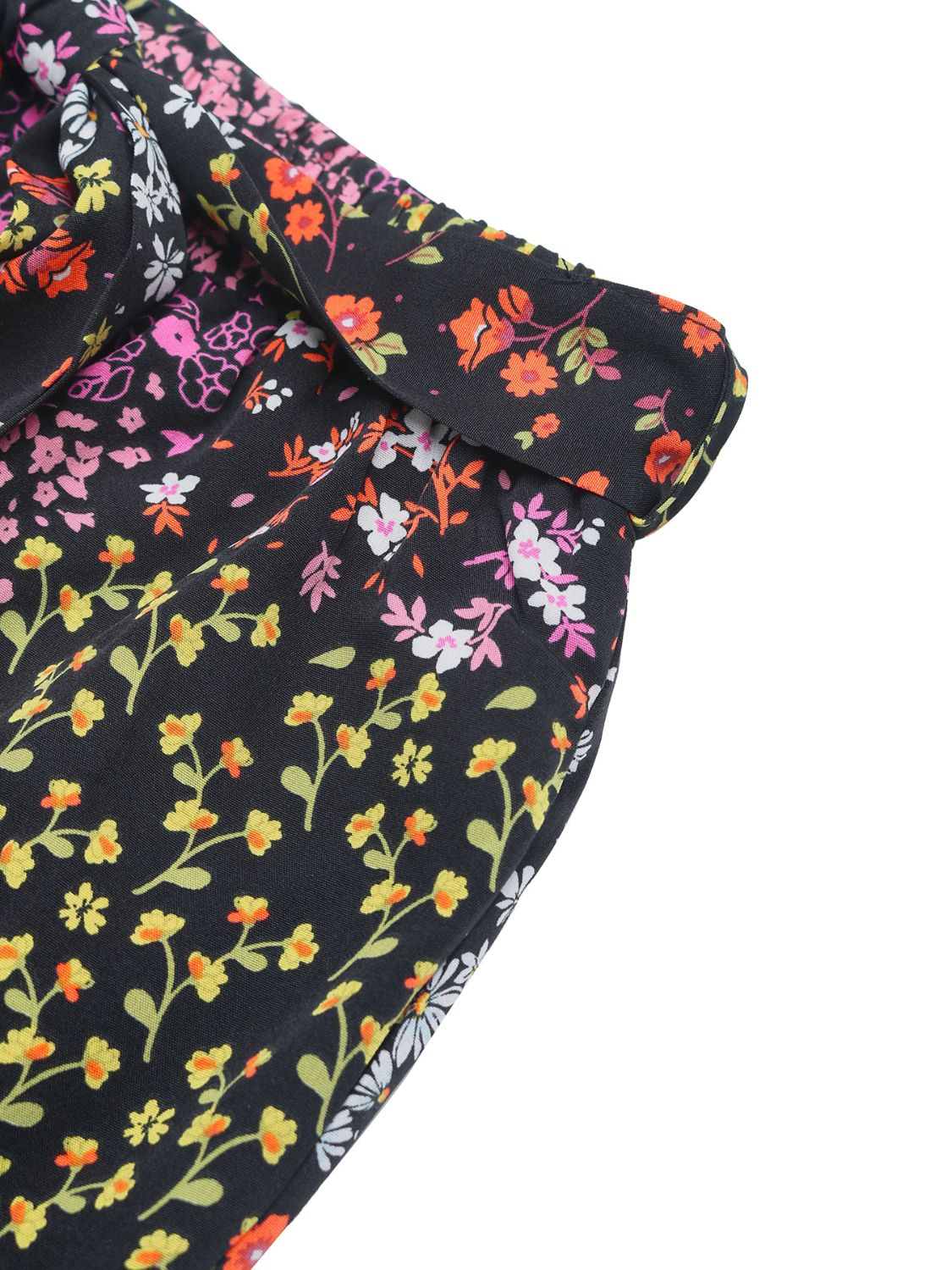 Black palazzo trousers with a vibrant floral print and a tie-waist detail.